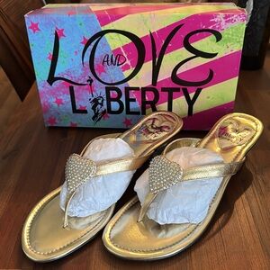 Love and Liberty made in the USA Gold with heart embellishment. New in box Sz 11